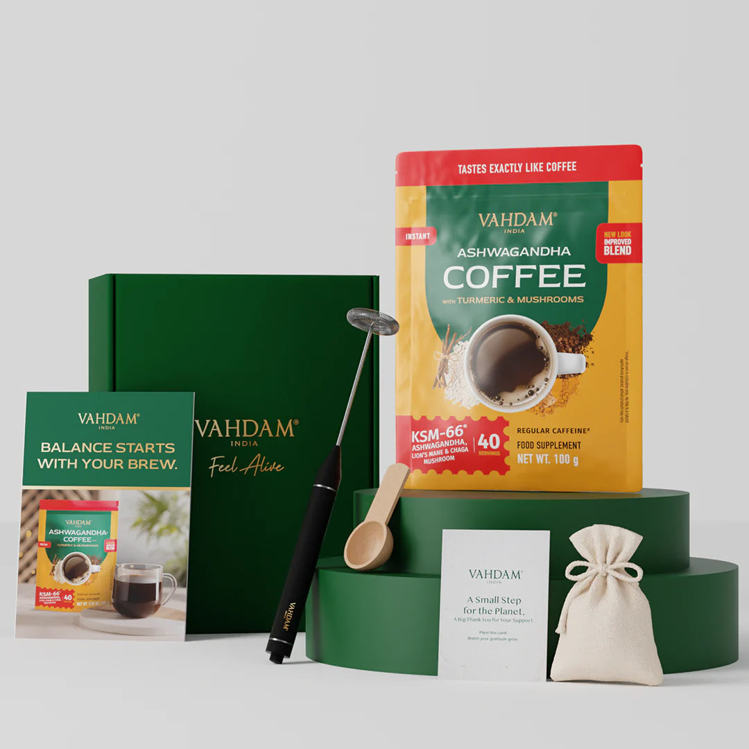 Vahdam coffee packaging with a green box, spoon, frother and gifts on a light gray background